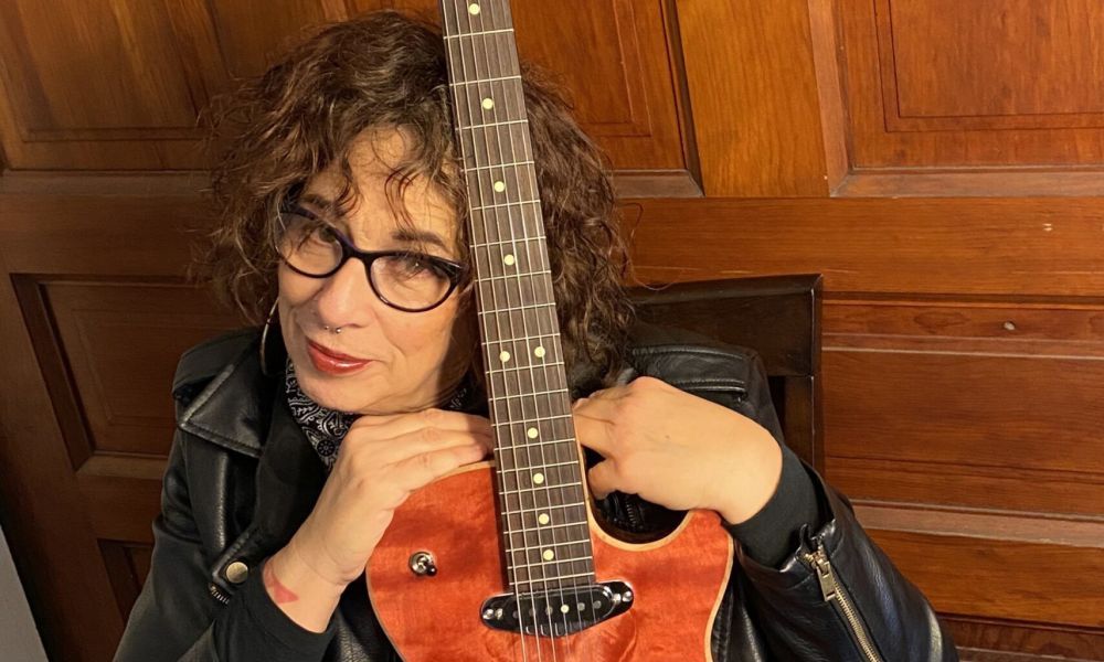 Joanna Connor poses with a guitar.